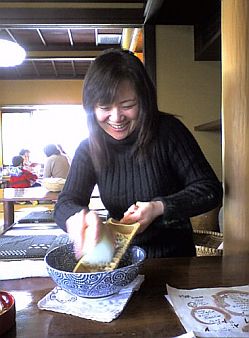 A lady filing radish with the grater